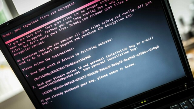 Picture of a laptop monitor with DoS style text which indicates a malware attack