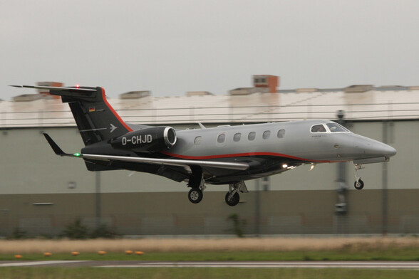 A Phenom 300 business jet just before touchdown