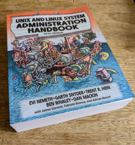 Vorderseite des Unix and Linux System Administration Handbooks, 5. Auflage, auf einem Holztisch