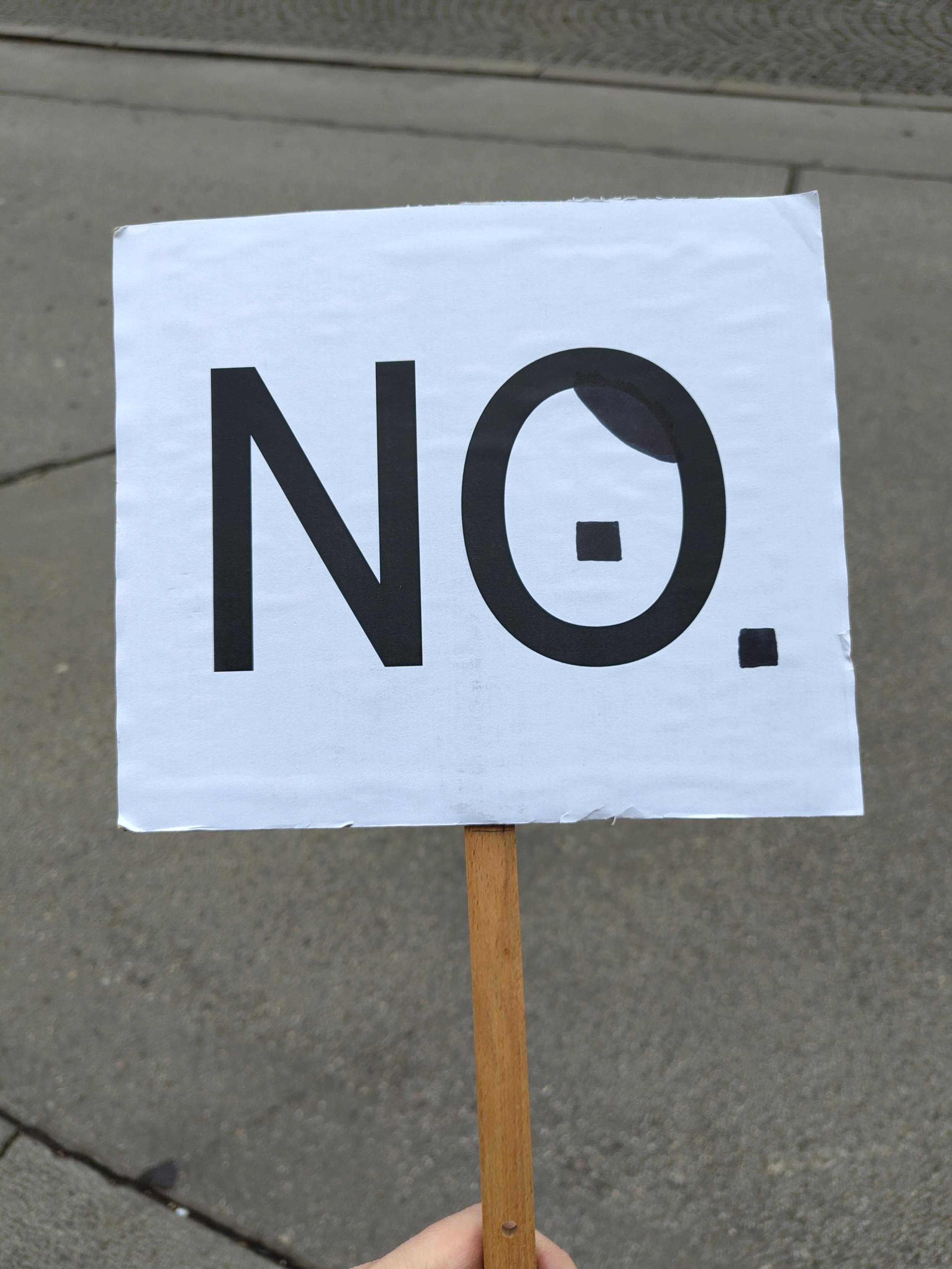 Schild mit "NO", wobei das O ein Hitlerbärtchen hat.